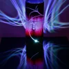 Art glass lamp using its internal LED, lamp shown on a back plexiglass sheet displaying brilliant mirrored image and projected color images on backdrop