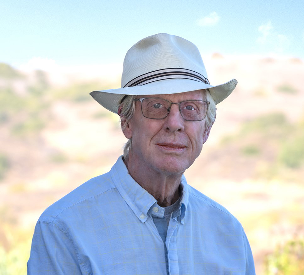 Photo of Terry Schilling, posing with hills in the background - thinking about creating a unique glass lamp.