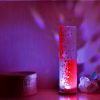 Shown on a display shelf displaying projected color images on backdrop using its internal LED.