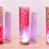 Flood lit views of lamp in three stages of rotation are arranged in a triptych.