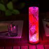 Lamp shown in an outdoor dining scene at night providing a dramatic center piece for guests.