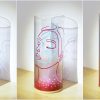 Flood lit views of lamp in three stages of rotation are arranged in a triptych.