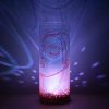 Shown on a display shelf displaying brilliant projected color images on backdrop using its internal LED.