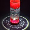 Lamp shown under spot light set directly overhead. Photo displays marvelous projected patterns of light and shadow surrounding base of lamp.