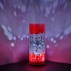 Shown in a corner of a display shelf displaying brilliant projected color images on backdrop using its internal LED.