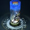 Lamp shown under spot light set directly overhead. Photo displays marvelous projected patterns of light and shadow encircling base of lamp.