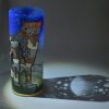 Shown under spot light at upper left, lamp displays brilliant projected color and shadow patterns. Highlighted are displays of patterns through clear glass.