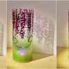 Flood lit views of lamp in three stages of rotation are arranged in a triptych.