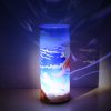 Lamp shown displaying brilliant projected images on backdrop using its internal LED along a with spot light.