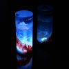 Lit only by its LED, lamp shown set on reflective black plexiglass and also as a side backdrop, lamp displays duel brilliant mirrored images.