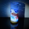 Lamp shown displaying brilliant projected images on backdrop using its internal LED along a with spot light while also set on reflective black plexiglass.