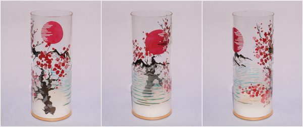 Lit by natural sun light, views of unique art glass lamp show at three stages of rotation here arranged in a triptych.