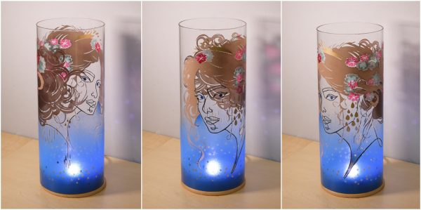 Lit by natural sun light, views of unique art glass lamp show at three stages of rotation here arranged in a triptych.