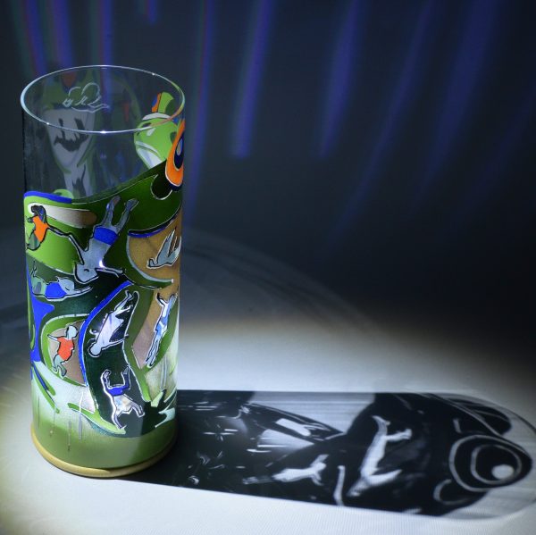 Shown under spot light at upper left, lamp displays brilliant projected color and shadow patterns. Also highlighted are displays of clear glass patterns