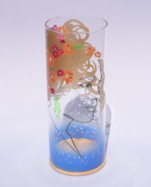 Lamp shown with flood lit backdrop displaying face view. Notice striking overlap between images displayed on front and rear.