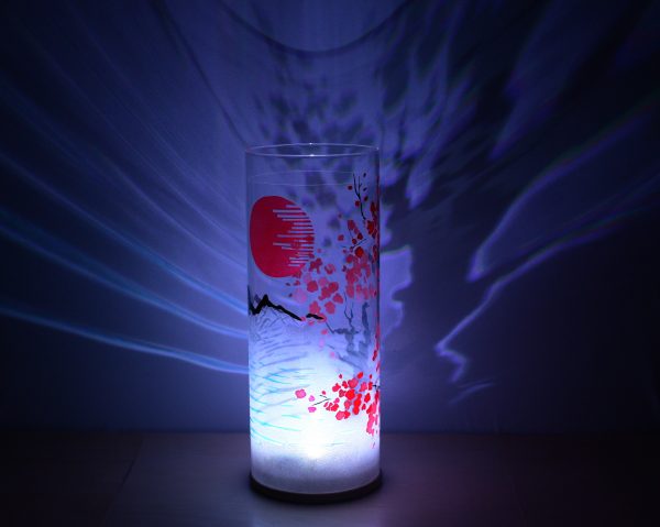 Shown with only LED. Unique art glass lamp displays brilliant shadow patterns on backdrop.