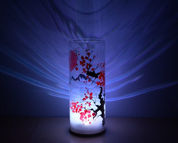 Shown with only LED. Unique art glass lamp displays brilliant shadow patterns on backdrop.