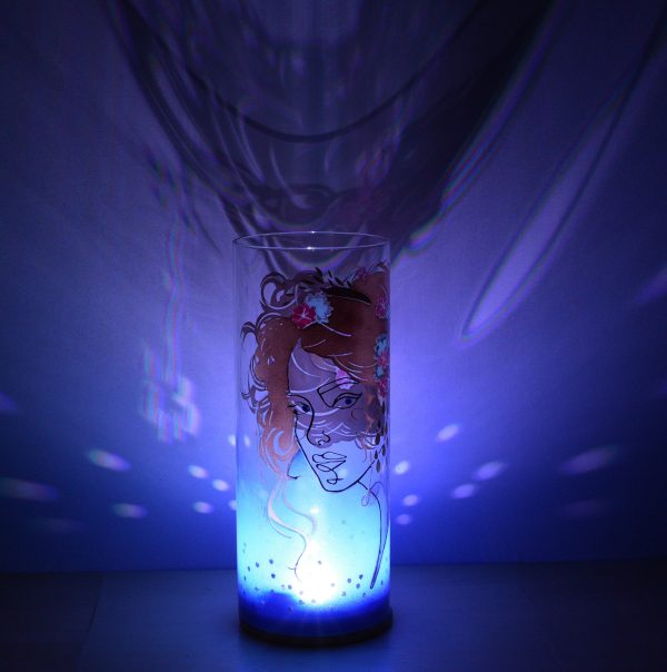 Shown with only LED. Unique art glass lamp displays brilliant shadow patterns on backdrop. View B