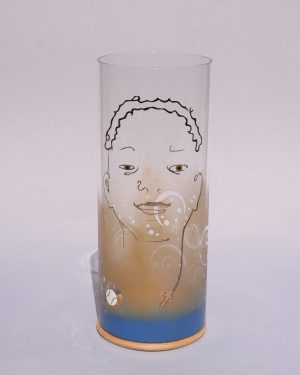 Unique art glass Lamp shown lit by full sun, front view.