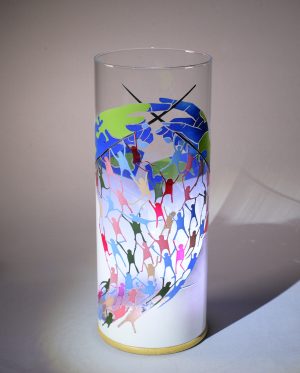 Anje Rozan unique art glass lamp shown against flood lit backdrop displaying face view.