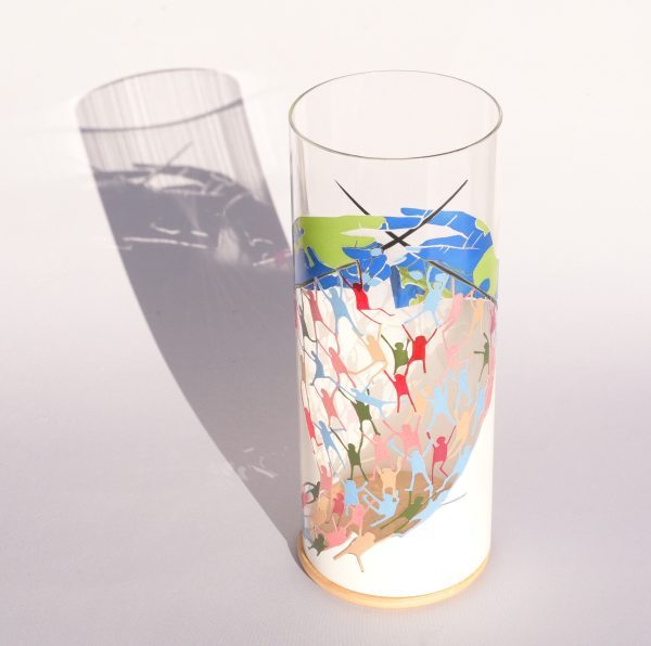 Anje Rozan art glass lamp shown under flood light displaying shadow image projected on a backdrop.