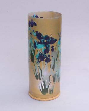 Art glass lamp shown against flood lit backdrop.
