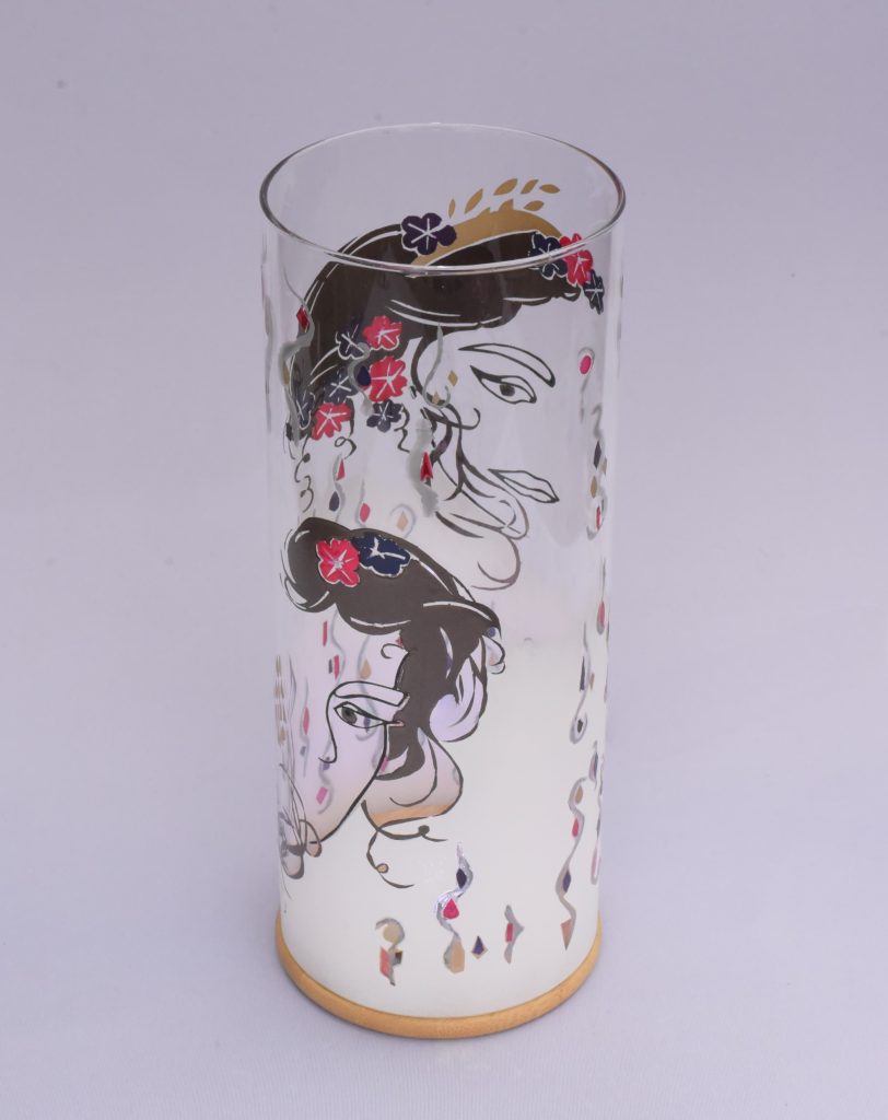 Unique art glass Lamp shown lit by full sun. Two halves of her face are shown.