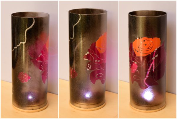 Art glass lamp lit by the LED shown in three stages of rotation arranged in a triptych.
