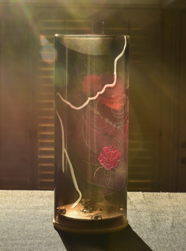 Lamp shown on display counter at sun rise bathed in full sun. Front view.