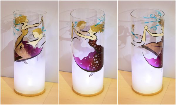 Art glass lamp lit by the LED shown in three stages of rotation arranged in a triptych.