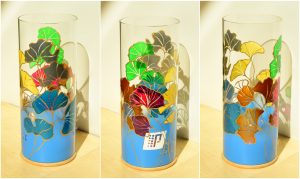 Ginkgyh Trip Art glass lamp lit by the LED shown in three stages of rotation arranged in a triptych.