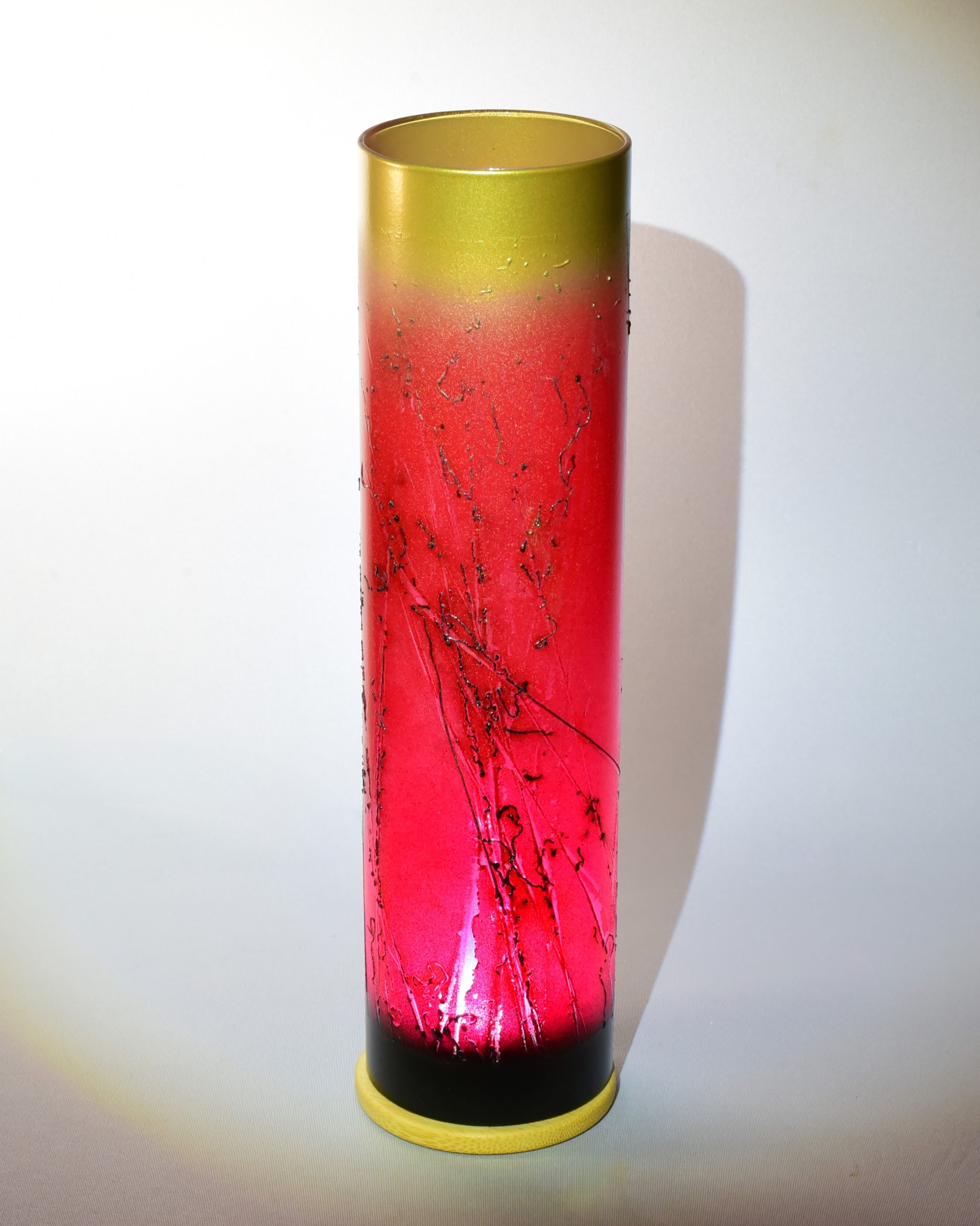 Scorched horse tail hair applied over red glaze with two more glazes at the top and bottom.