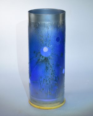 Face view of powder glazed table lamp, flood lit.