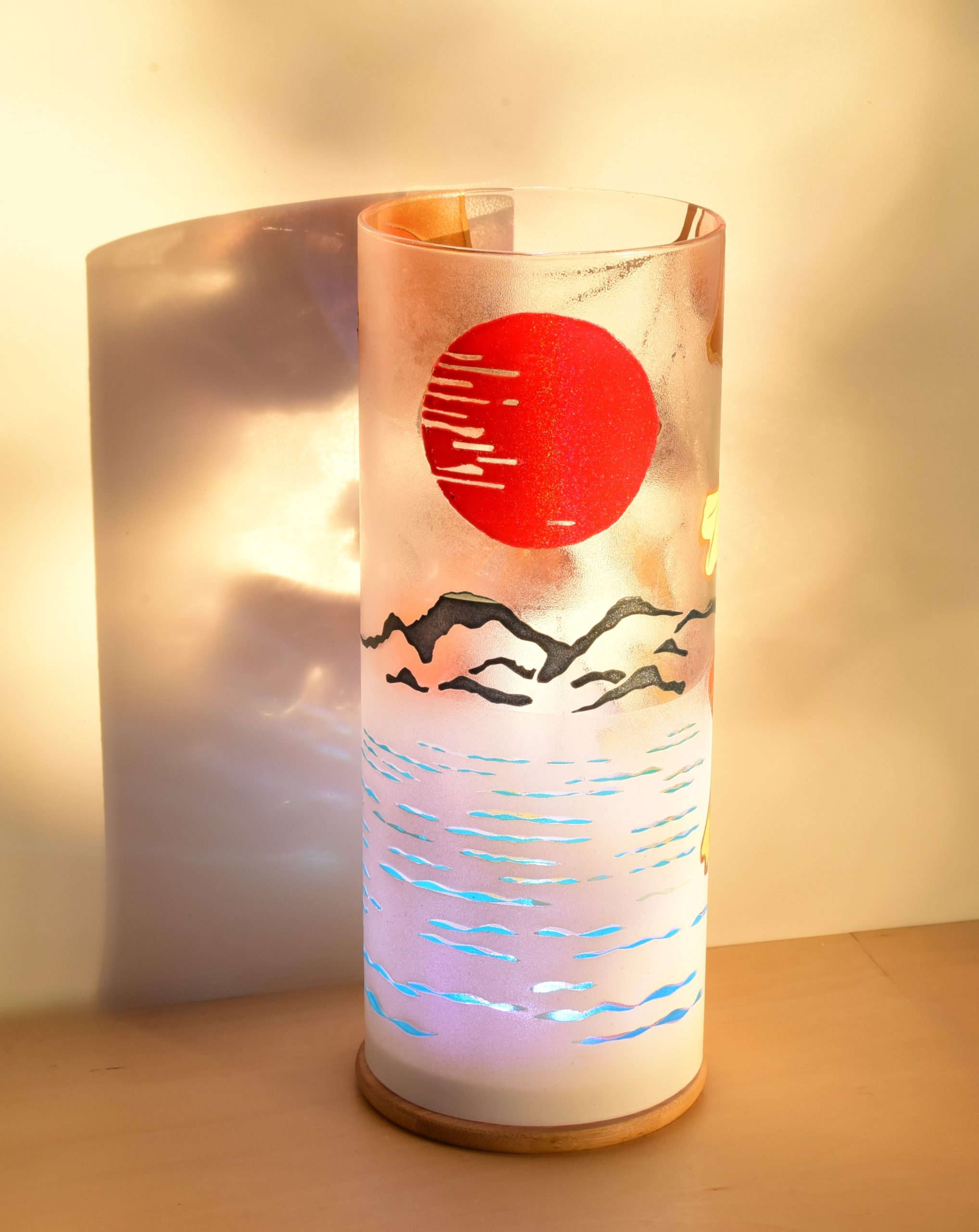 At sunrise, lit from only one side showing projected images on backdrop.