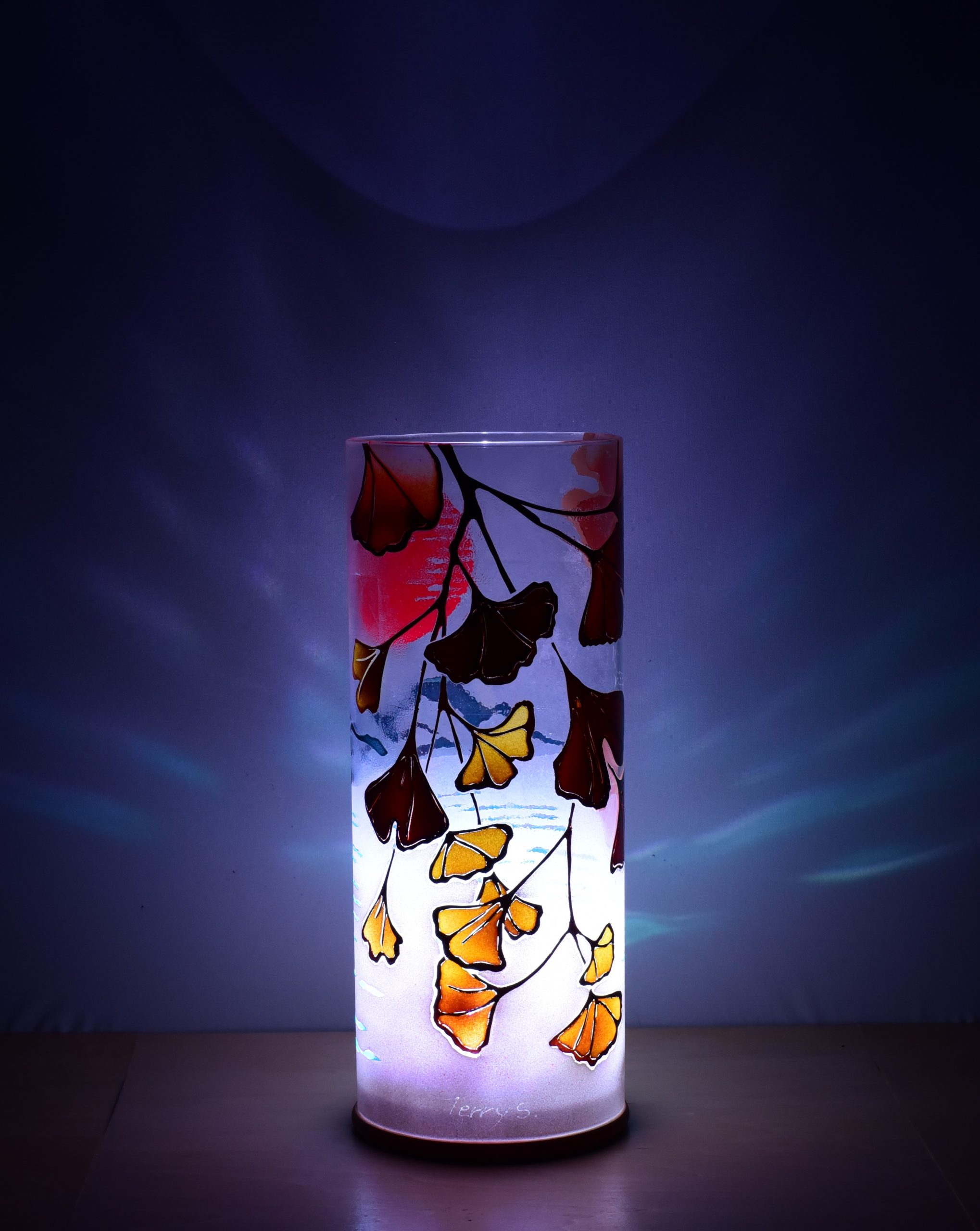 Shown with only LED illuminated. One-of-kind art accent lamp displays brilliant color patterns on backdrop.