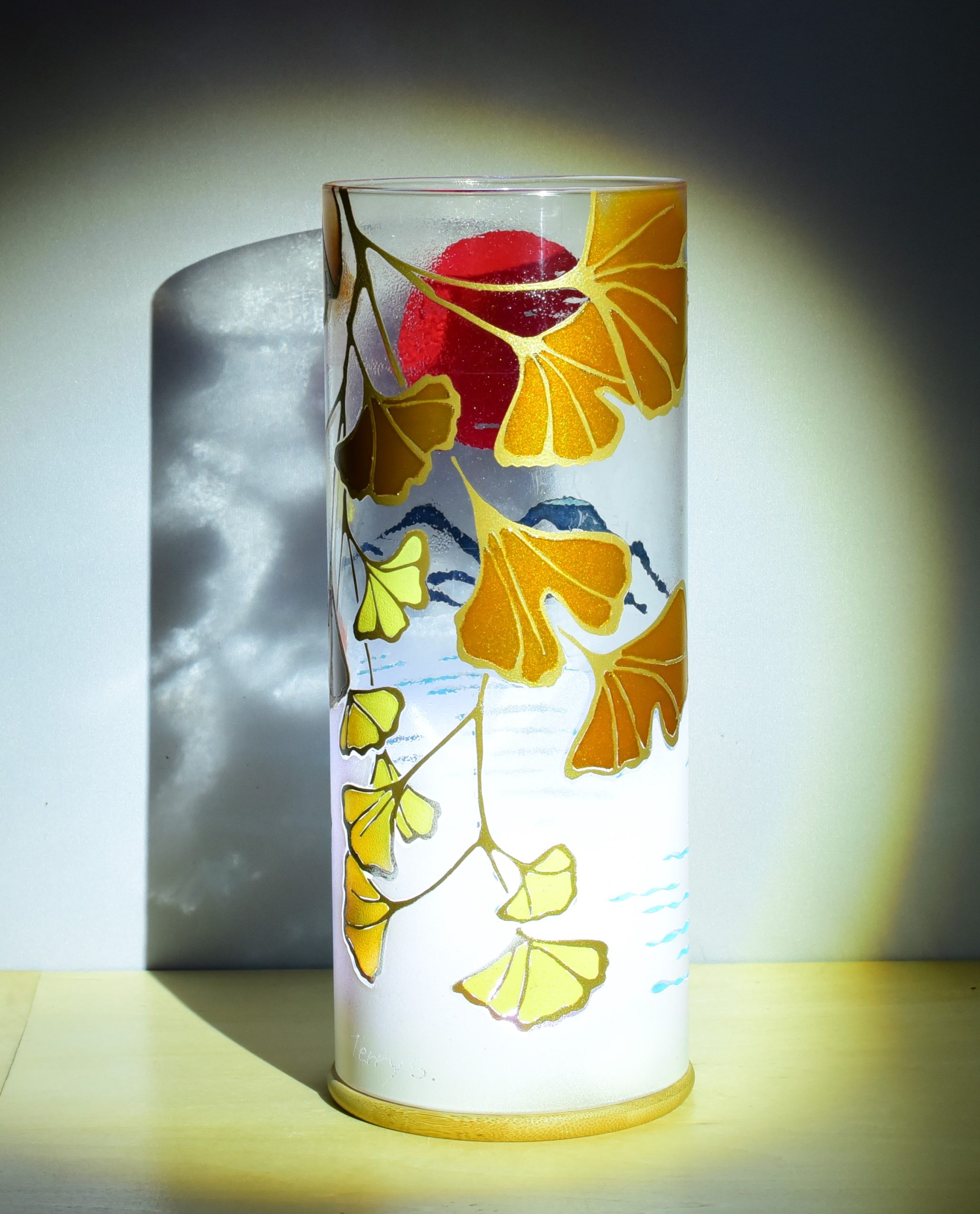 Unique accent lamp shown under spot light displaying transposed views of front and rear of lamp