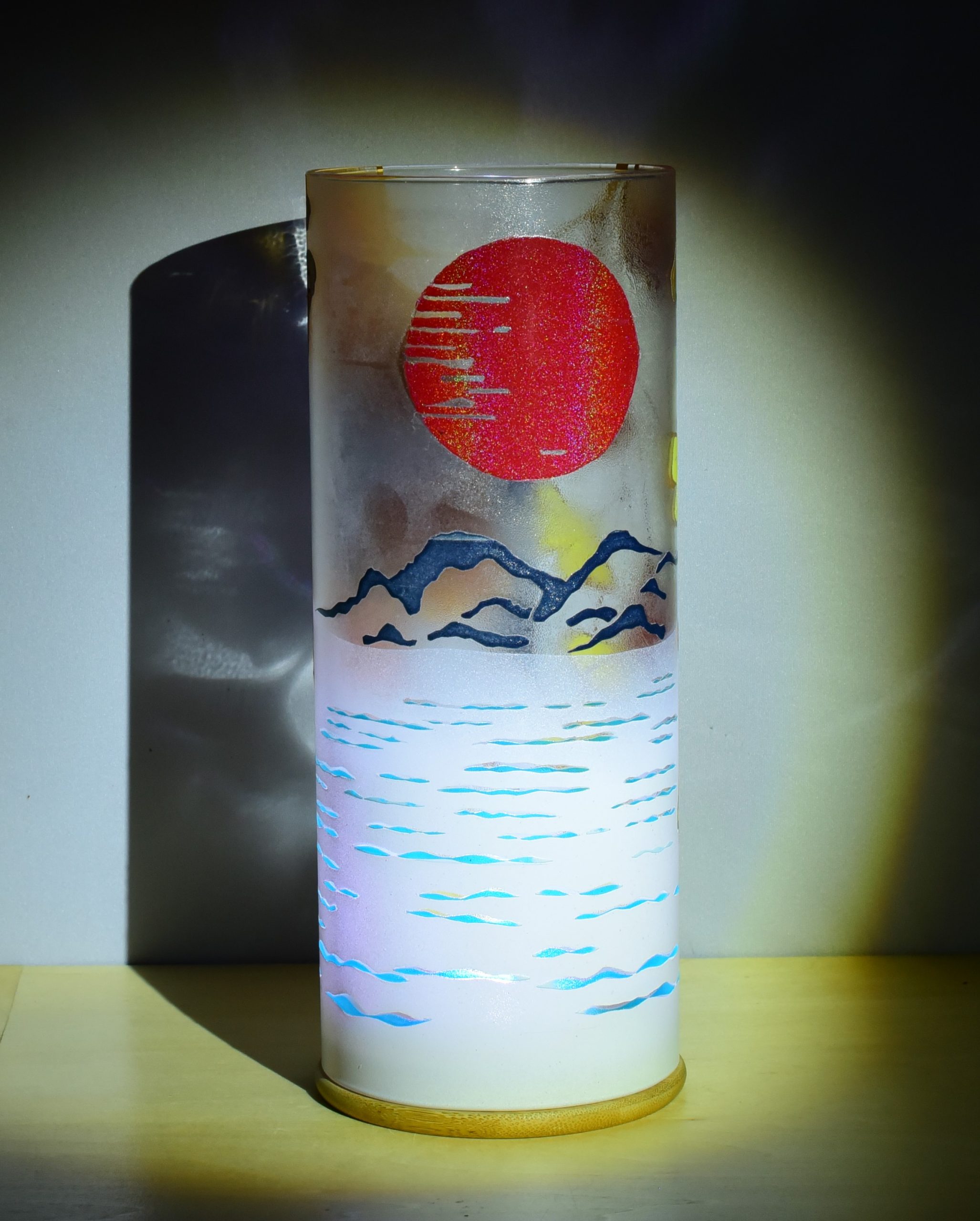 Unique accent lamp shown under spot light displaying glow of inner LED through ripples of water.