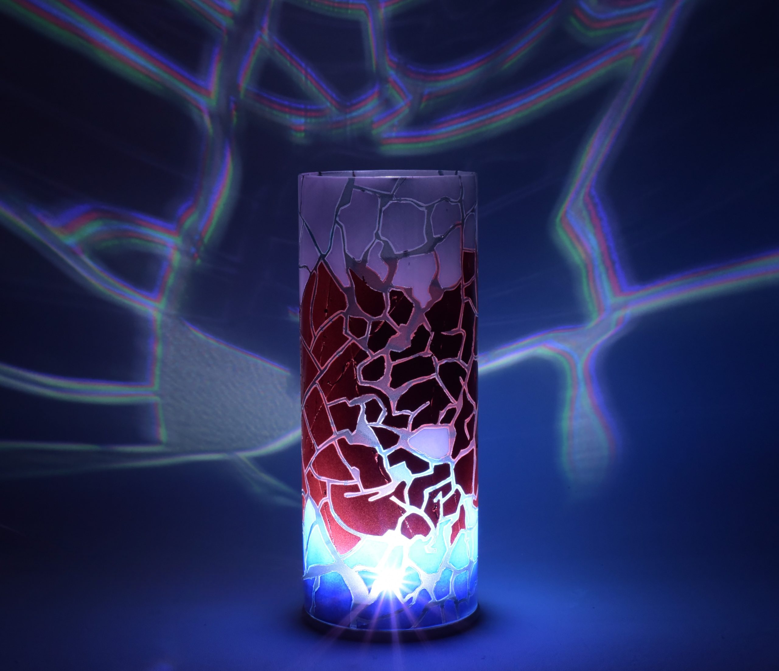 Shown with only LED illuminated. One-of-kind art accent lamp displays brilliant color patterns on backdrop.