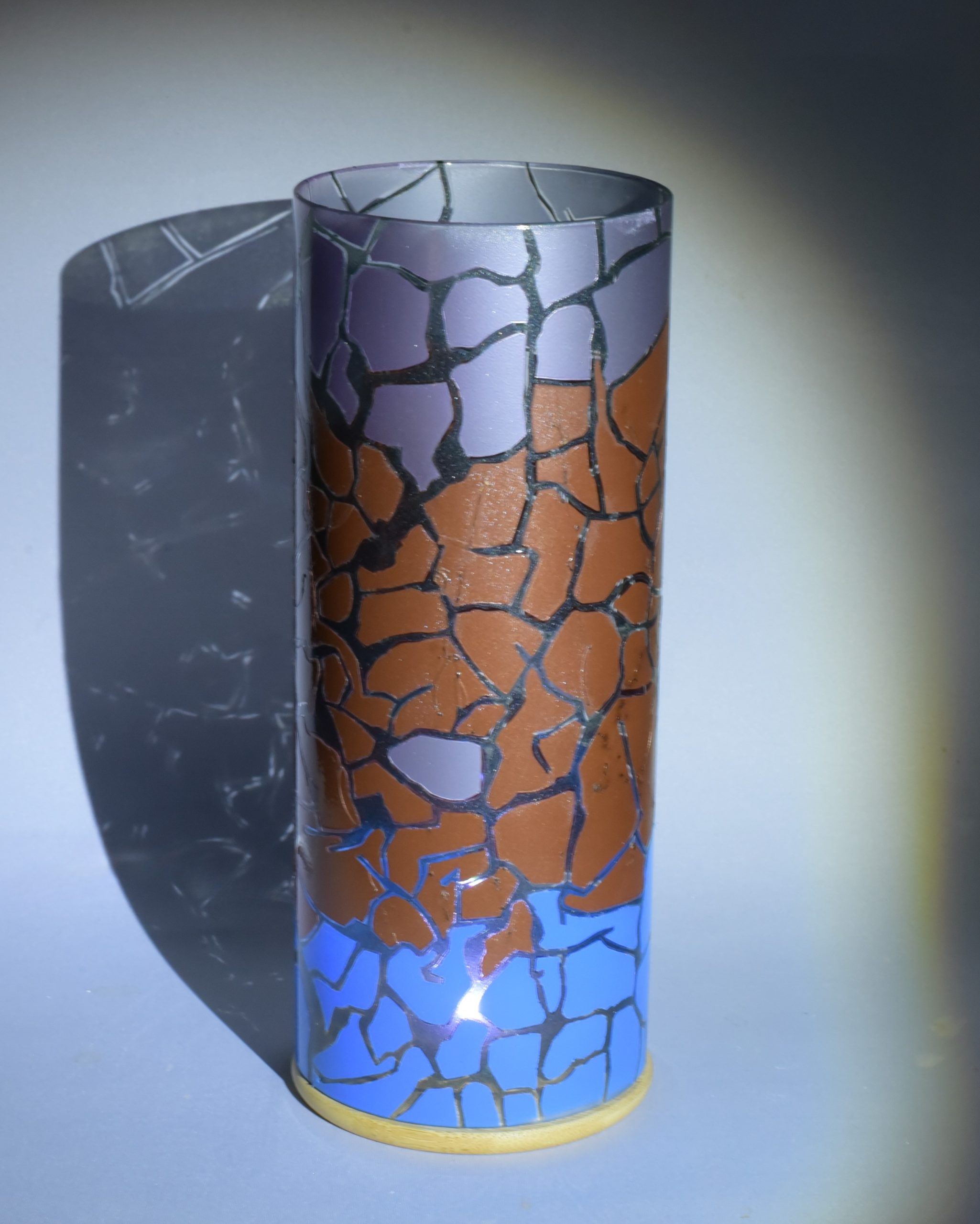 Unique accent lamp shown under spot light. Photo displays projected patterns in shadow of lamp.