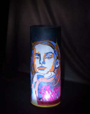 Unique accent lamp shown under spot light on black velvet.