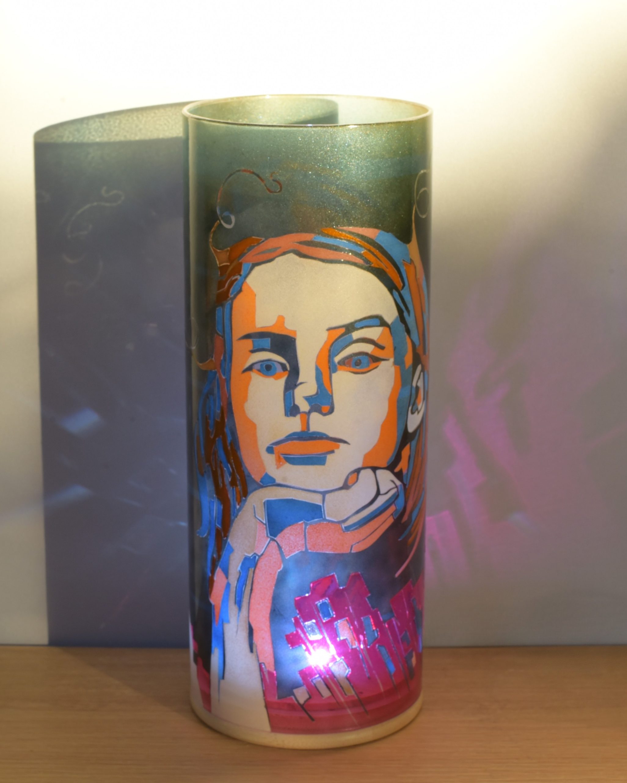 At sunrise, lit from only one side showing projected images on backdrop.