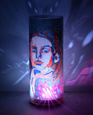 Shown with only LED illuminated. One-of-kind art accent lamp displays brilliant color patterns on backdrop.