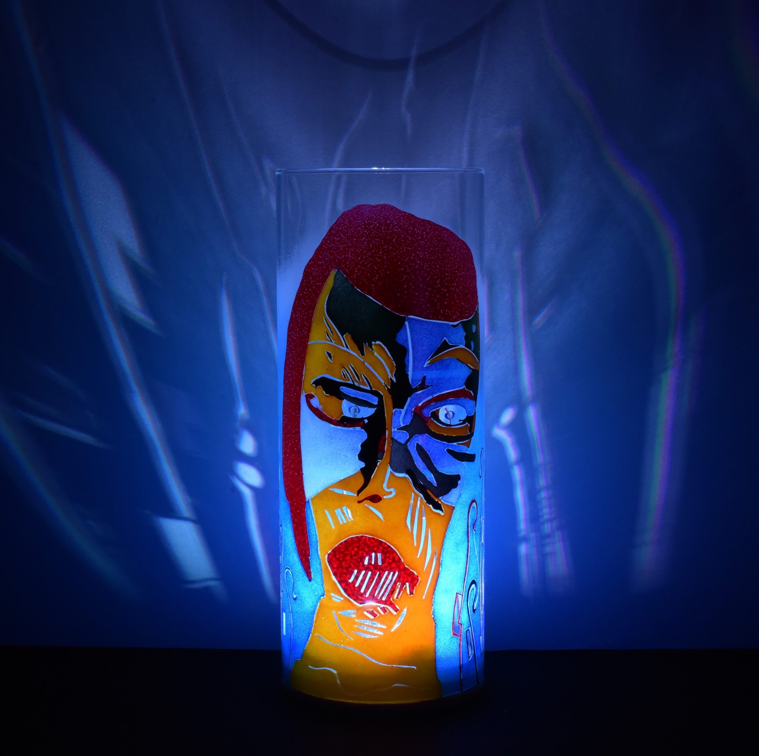 Shown with only LED illuminated. One-of-kind art accent lamp displays brilliant patterns on backdrop.