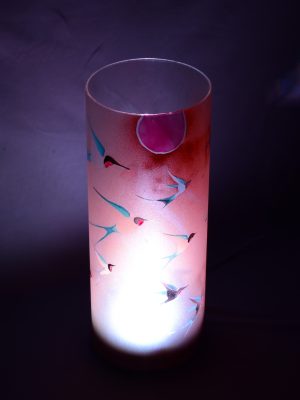 Accent lamp shown with only LED illuminated dramatically standing against a grey backdrop.